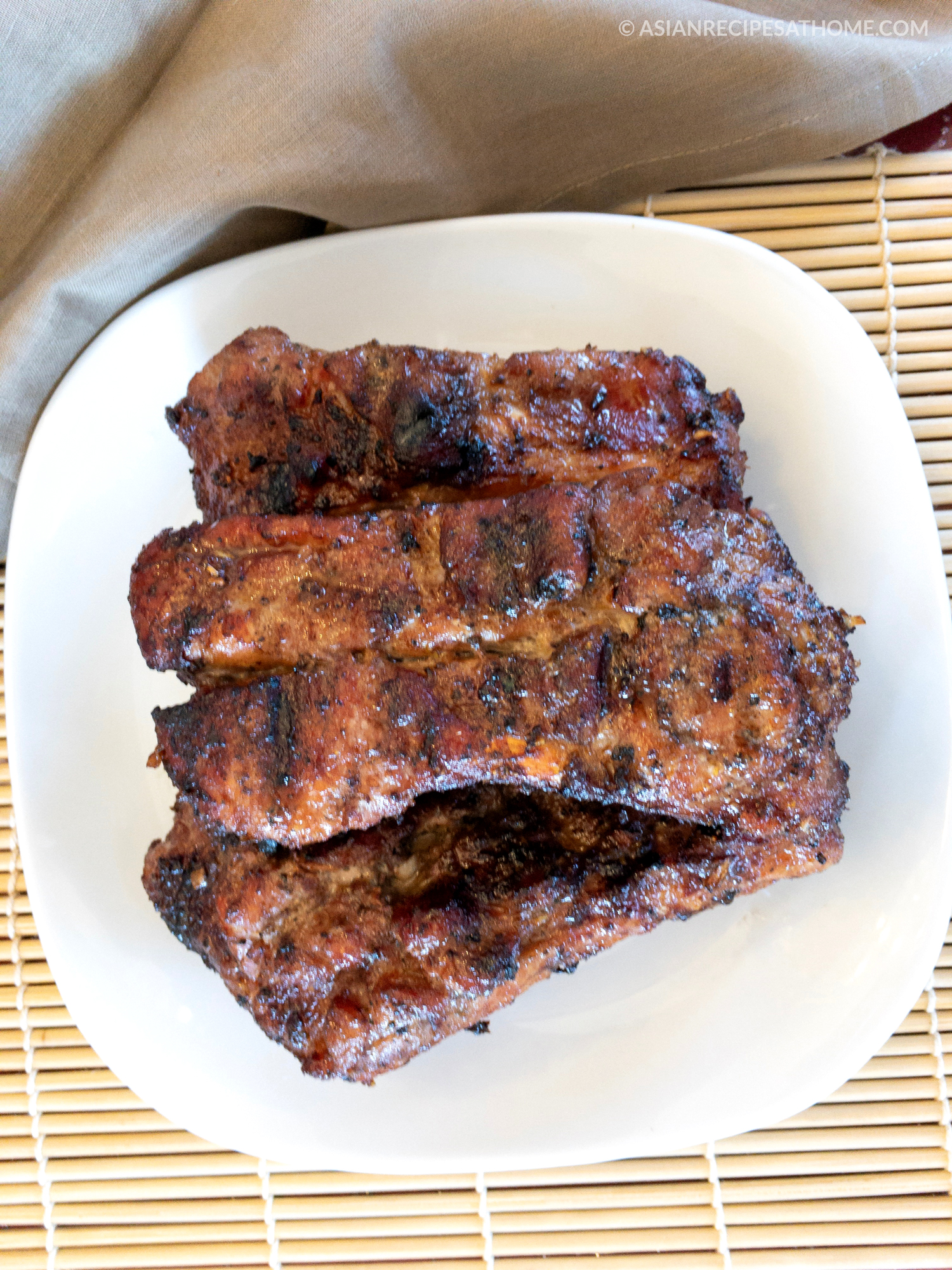 Pork ribs are marinated in a ginger, garlic, and coconut aminos marinade and then grilled to perfection.