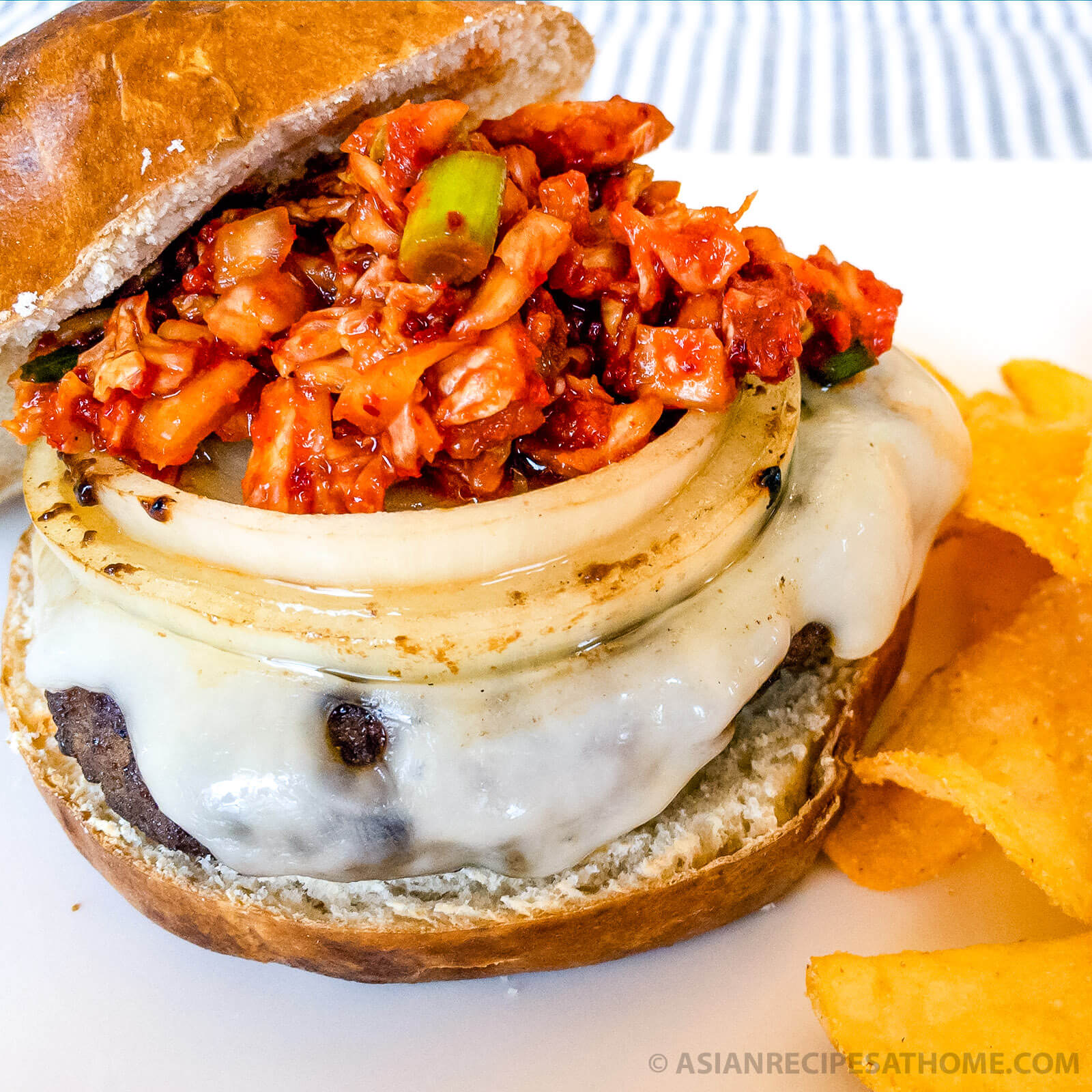 This Korean BBQ Bulgogi Burger recipe is marinated in a slightly sweet and savory marinade, cooked on the grill, and then topped with cheese and delicious homemade kimchi relish.