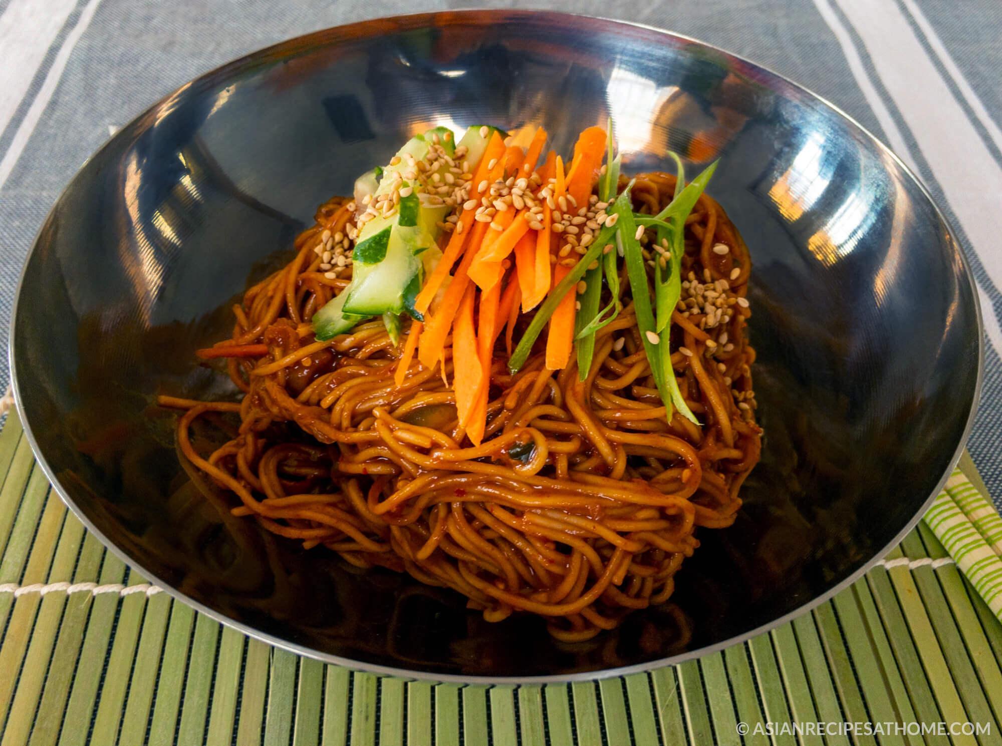 This cold, light and refreshing Korean noodle bowl recipe is easy to make, healthy and has a spicy kick from the sweet and sour gochujang sauce.