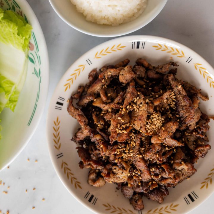 Thinly sliced pork is marinated in an Asian-style marinade, stir-fried and served with napa cabbage leaves to use as wraps.