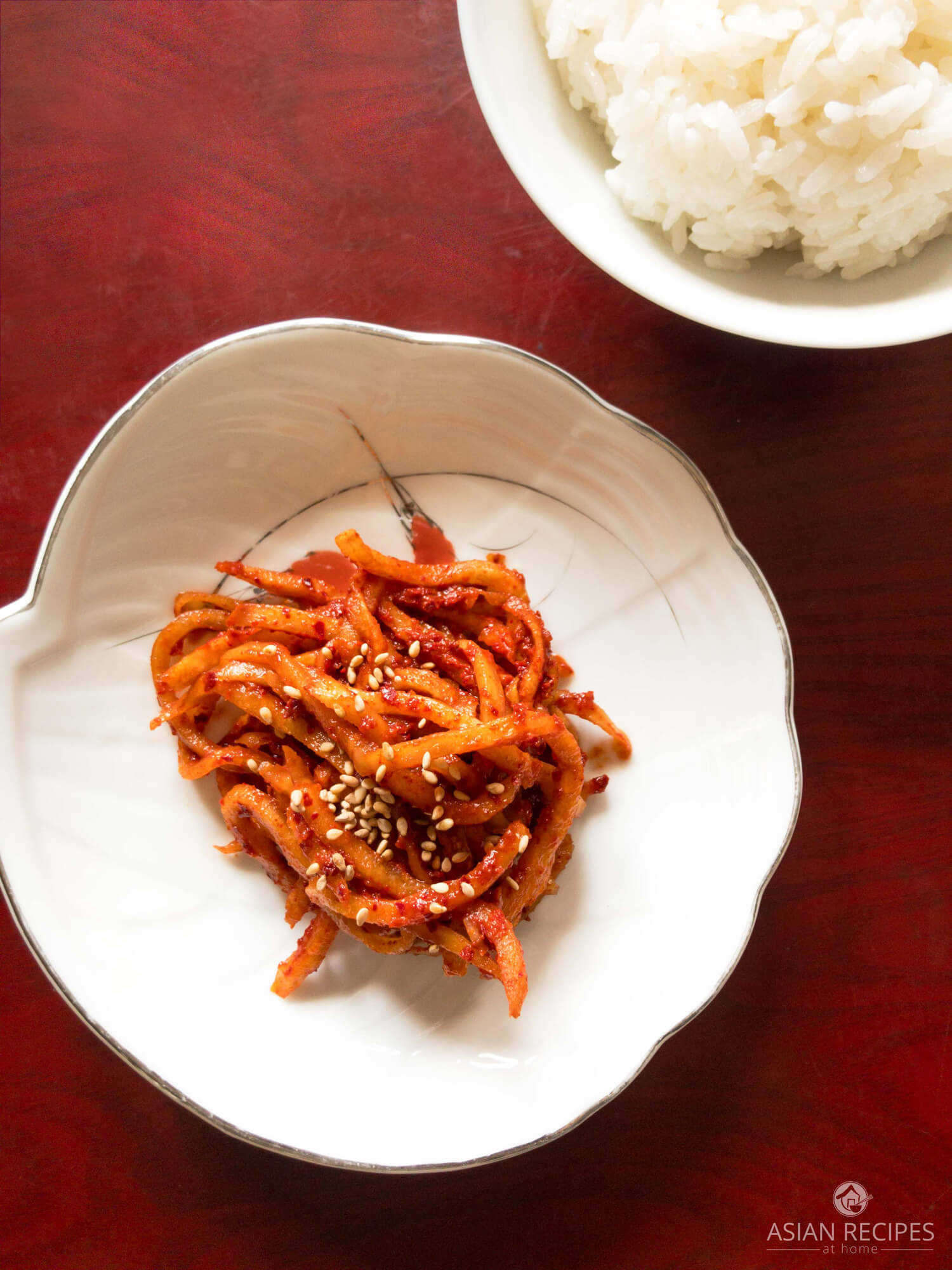 Fresh Korean radish is julienned into strands and then mixed with a spicy mixture to create a delicious and quick radish kimchi.