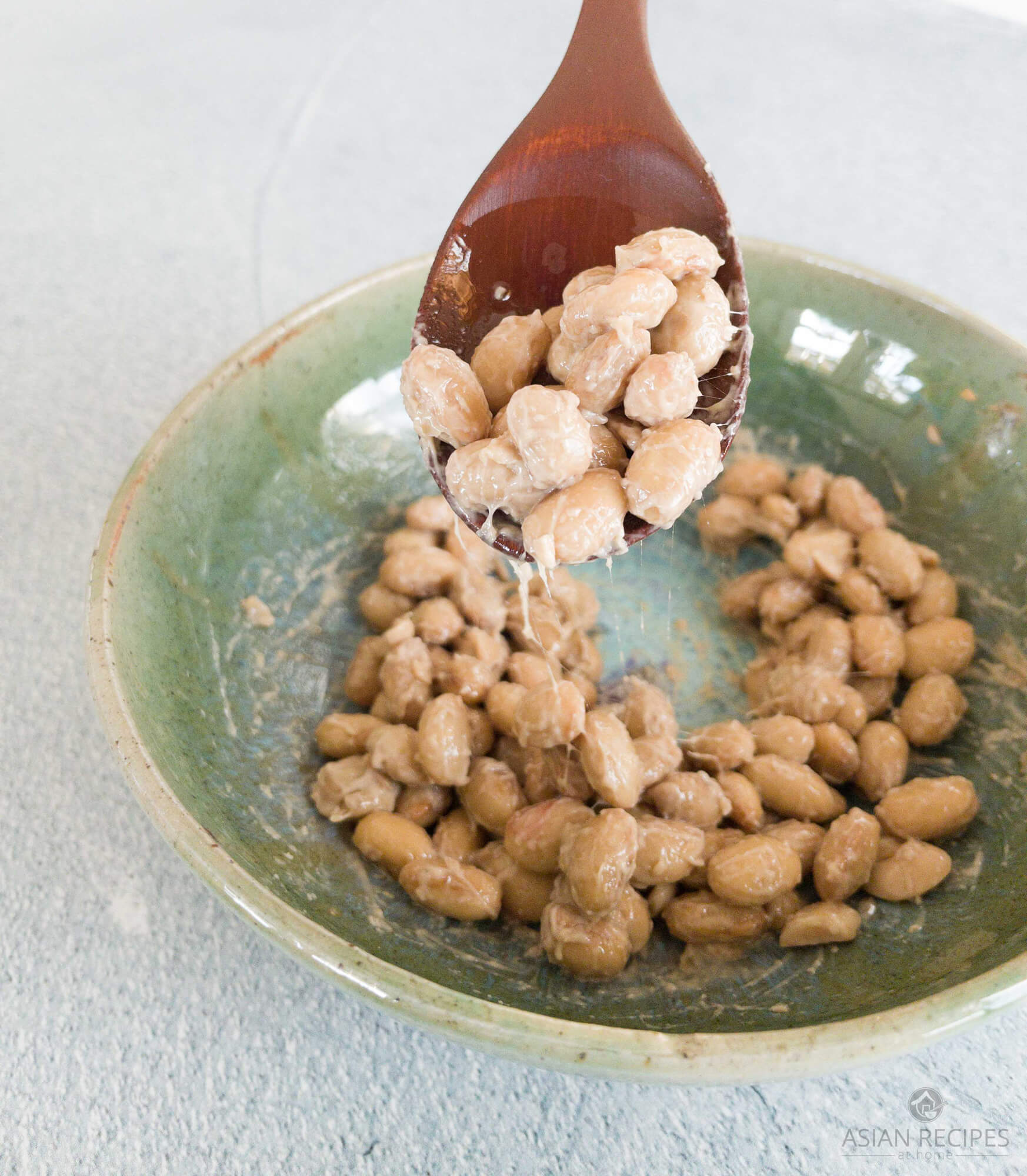 A spoonful of slimy natto (fermented soybeans).