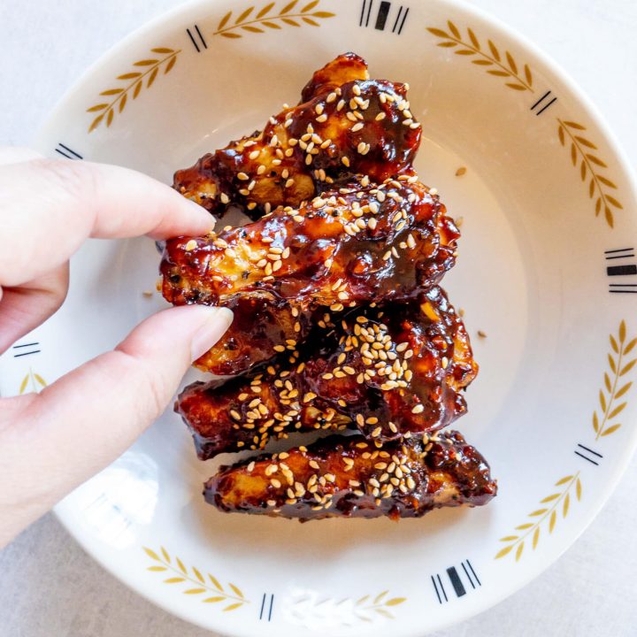It just takes about 30 minutes to cook wings in an air fryer that are served tossed in a delicious, spicy gochujang sauce!