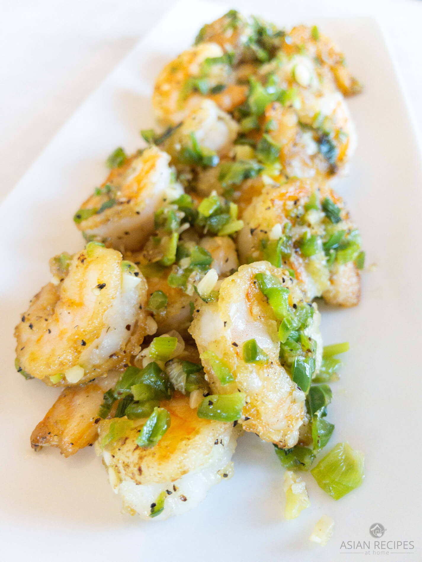 Shrimp are fried in avocado oil to a golden brown and tossed with peppers, garlic, green onion, salt, and pepper.