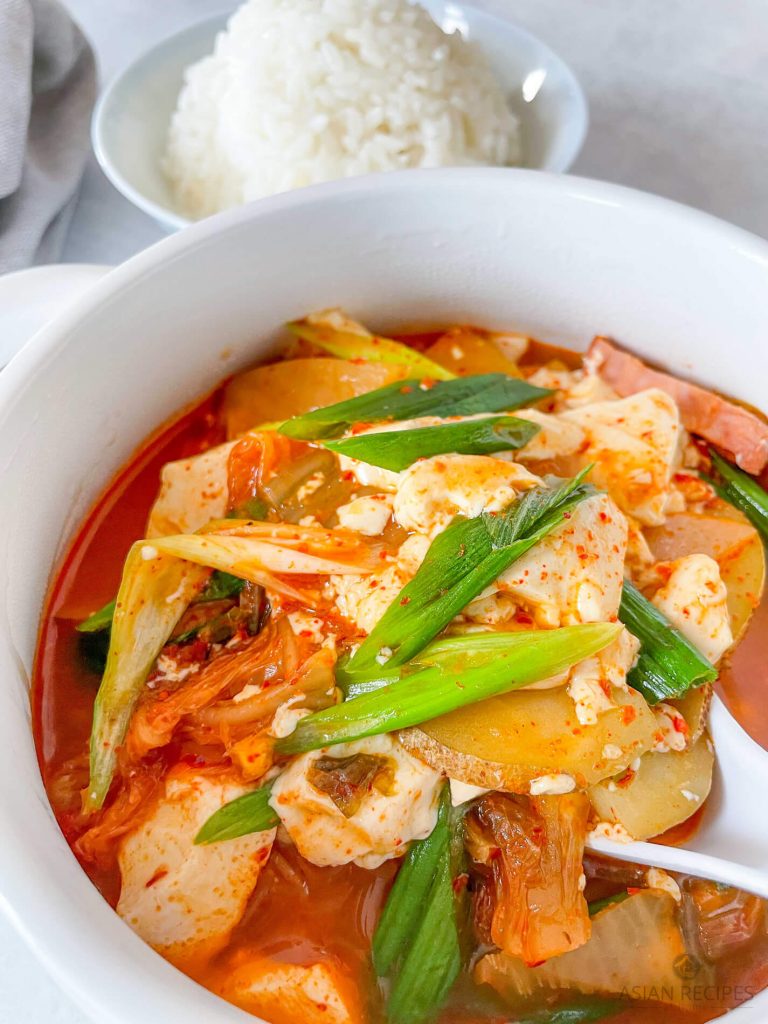 Make this easy kimchi soup recipe with fresh ingredients like aged kimchi, potatoes, ham, and green onions.