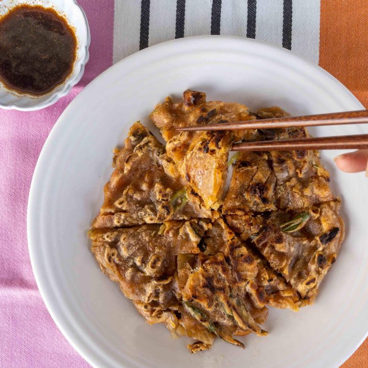 Pancakes made with kimchi, green onions, and cassava flour are pan-fried to a golden brown. This recipe is a great Whole30, Paleo, and gluten-free snack or appetizer idea!