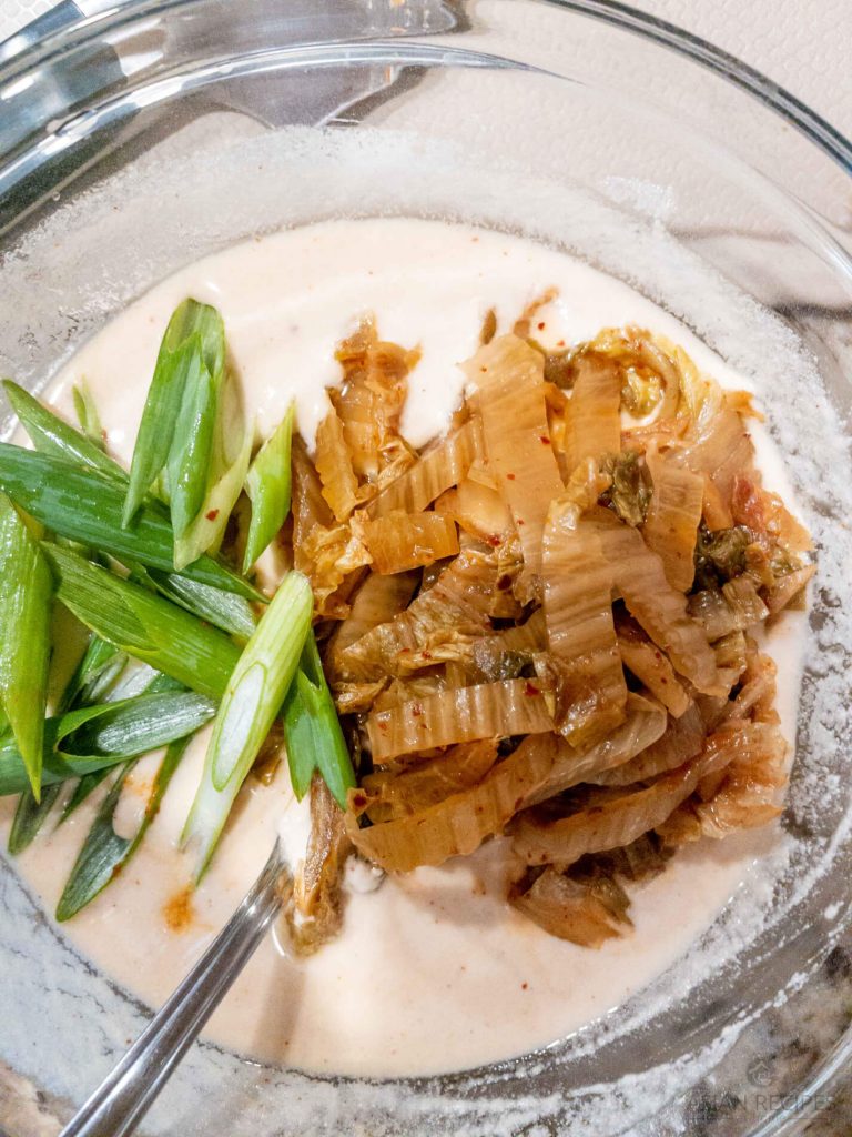 Mixing in aged kimchi and green onions into the Whole30 and Paleo pancake batter.