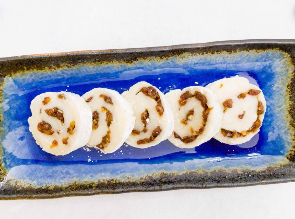 Freshly made sweet rice cake is filled with dates and honey. The rice cake is then rolled to make a delicious pinwheel Asian-inspired dessert or snack recipe. 