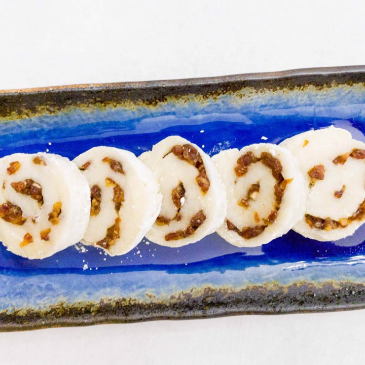 Freshly made sweet rice cake is filled with dates and honey. The rice cake is then rolled to make a delicious pinwheel Asian-inspired dessert or snack recipe.