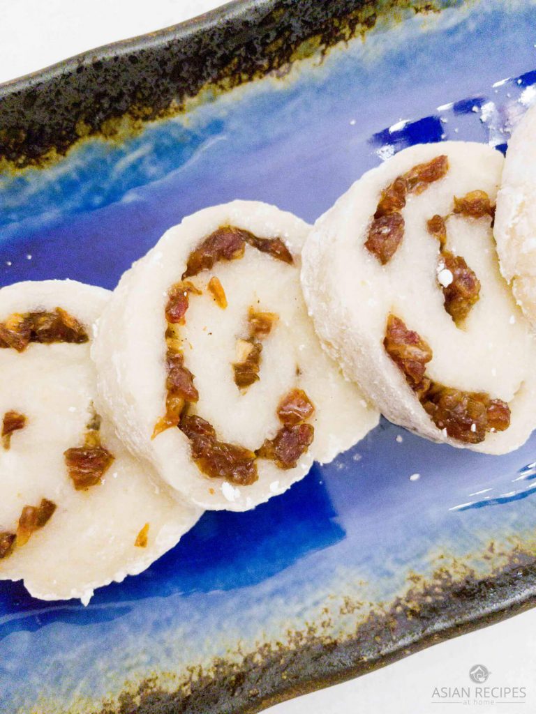 Freshly made sweet rice cake is filled with dates and honey. The rice cake is then rolled to make a delicious pinwheel Asian-inspired dessert or snack recipe. 